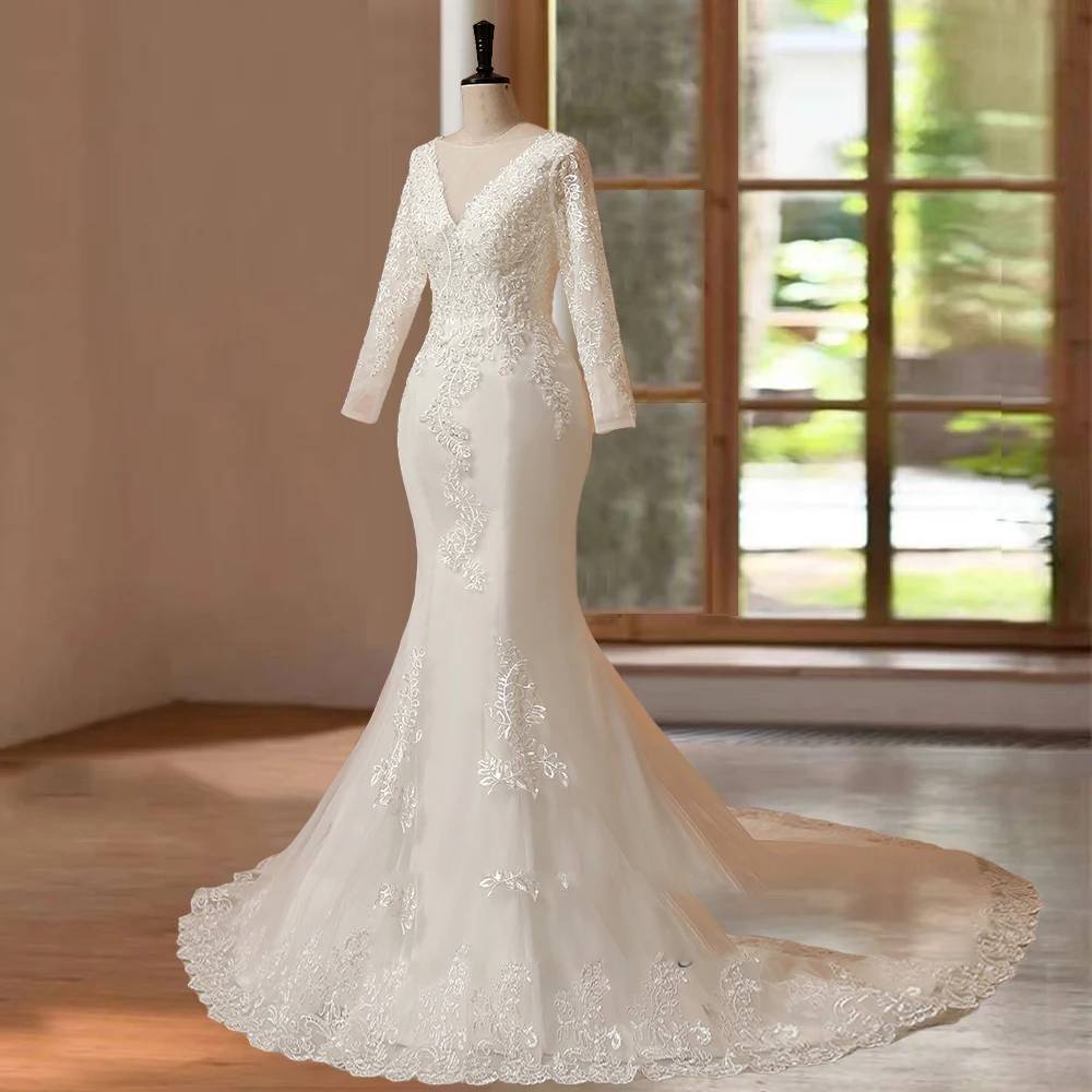 Three-quarter side angle of a luxury long sleeve O-neck mermaid wedding dress on a mannequin, emphasizing the tailored fit-and-flare hourglass silhouette and elegant lace appliqués.