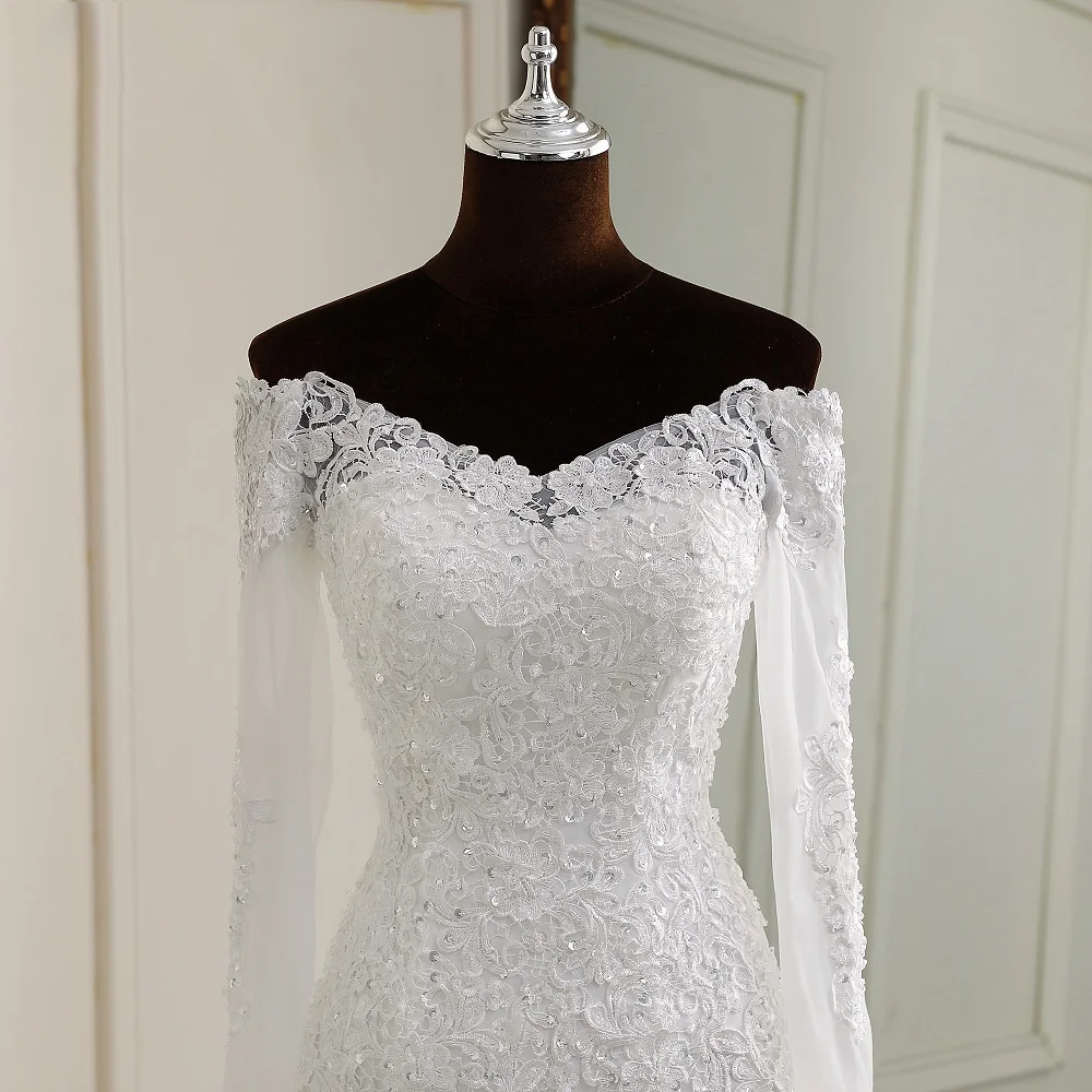 A detailed close-up of the delicate lace appliques and beadwork on the sleeves and bodice of an off-the-shoulder mermaid wedding gown.