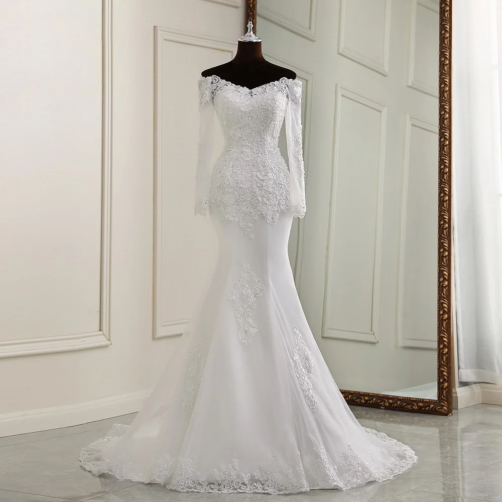 A mannequin display of an off-the-shoulder, long-sleeve mermaid wedding dress, focusing on the fitted silhouette and intricate floral lace applique design.