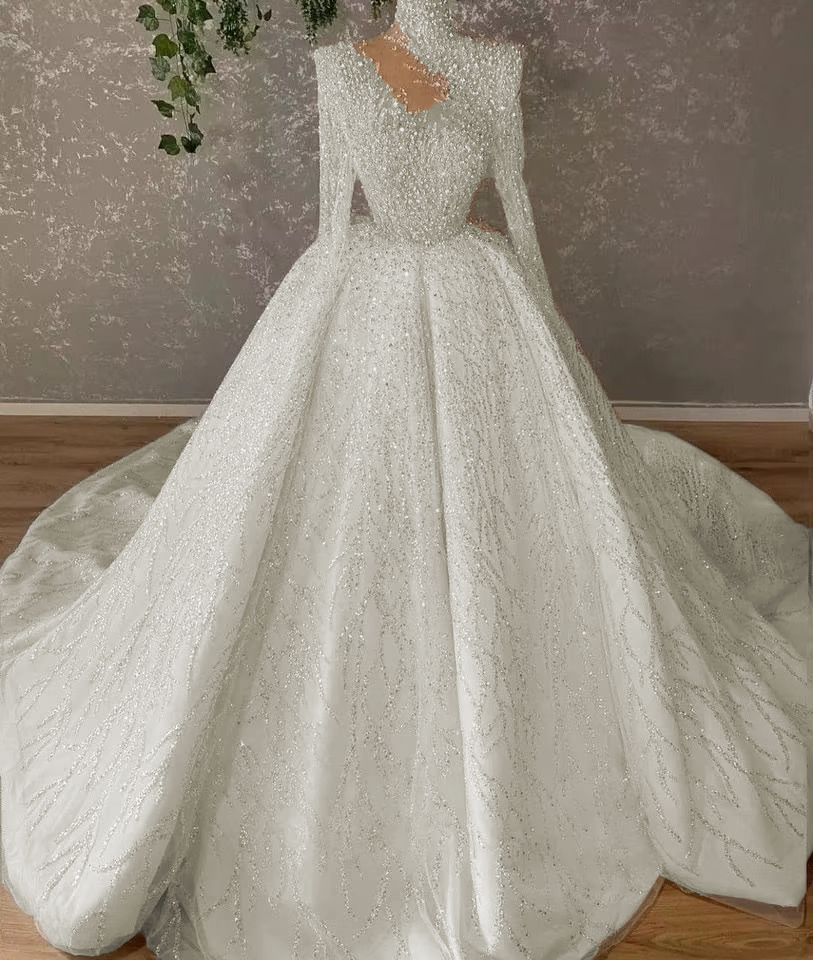 Exquisite close-up detail highlighting the high-shine glittering sequins, delicate lace appliques, and premium stitching along the bottom hemline of the custom bridal skirt.