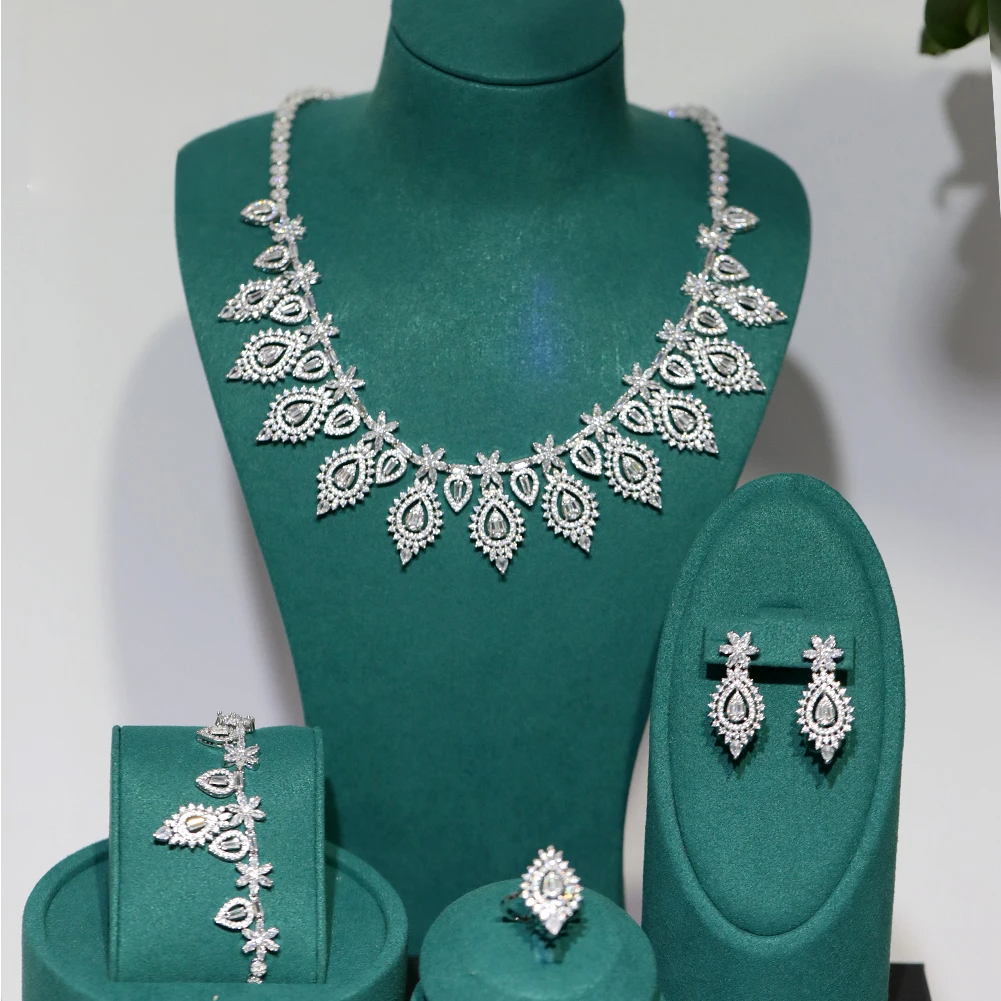 Front profile of a premium 4-piece cubic zirconia wedding accessory set displayed on green velvet jewelry mounts.