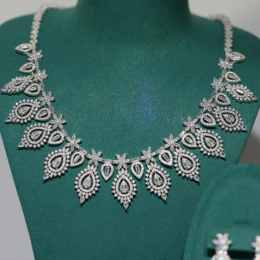 Detailed close-up macro shot of the cascading teardrop and floral cluster patterns on a silver AAA zirconia bridal necklace.
