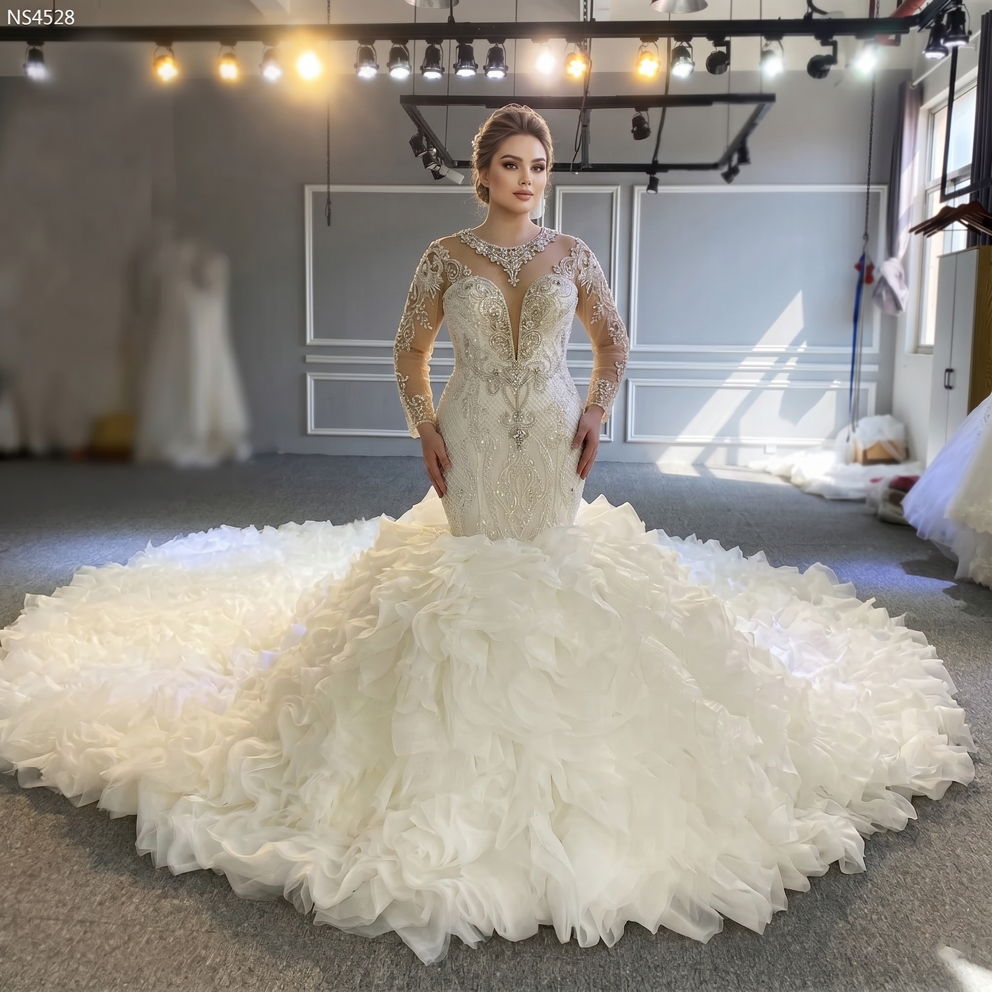 Elegant front pose of a shimmering mermaid bridal gown with intricate silver beading and long sleeves, showcasing the fitted silhouette without the overskirt in a studio setting