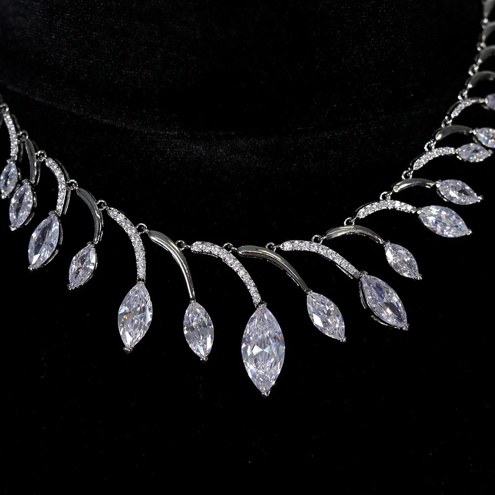 Detailed close-up macro shot of the central wave links and dangling marquise gems on a luxury African wedding necklace.