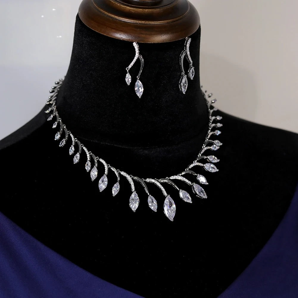 Perspective view of a luxury crystal wedding necklace and earrings set for women, demonstrating bright reflections.