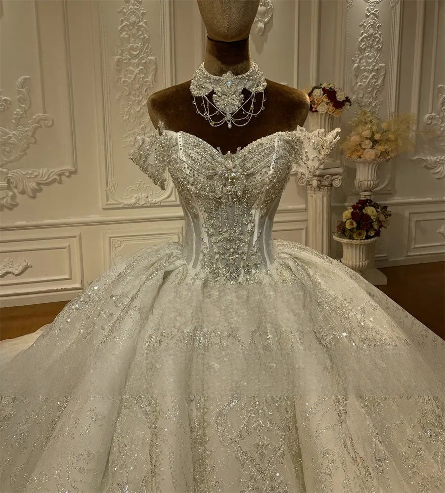 Close-up detail of the luxury beaded mermaid wedding gown bodice, highlighting the intricate heavy crystal beadwork, sweetheart neckline, and elegant detachable straps.