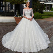 Elegant luxury A-line wedding dress featuring a sophisticated boat neckline, delicate lace appliques, and beaded three-quarter sleeves.