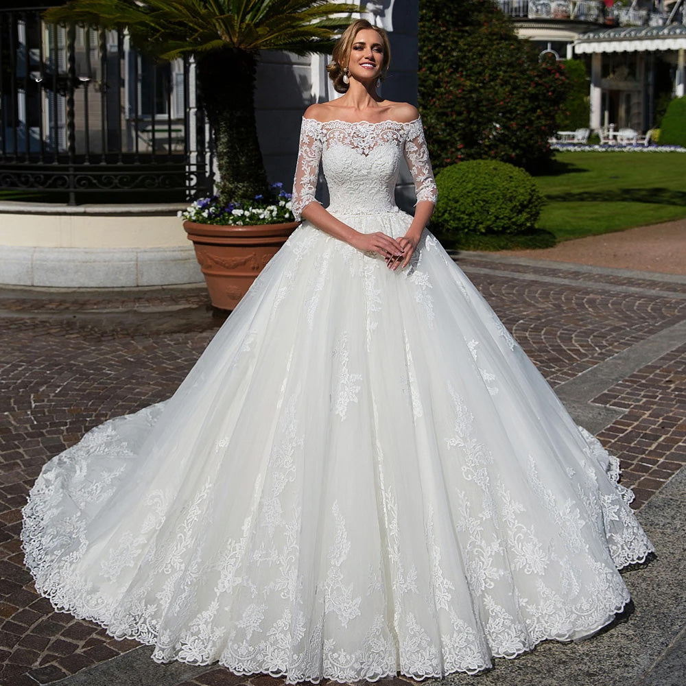 Elegant luxury A-line wedding dress featuring a sophisticated boat neckline, delicate lace appliques, and beaded three-quarter sleeves.