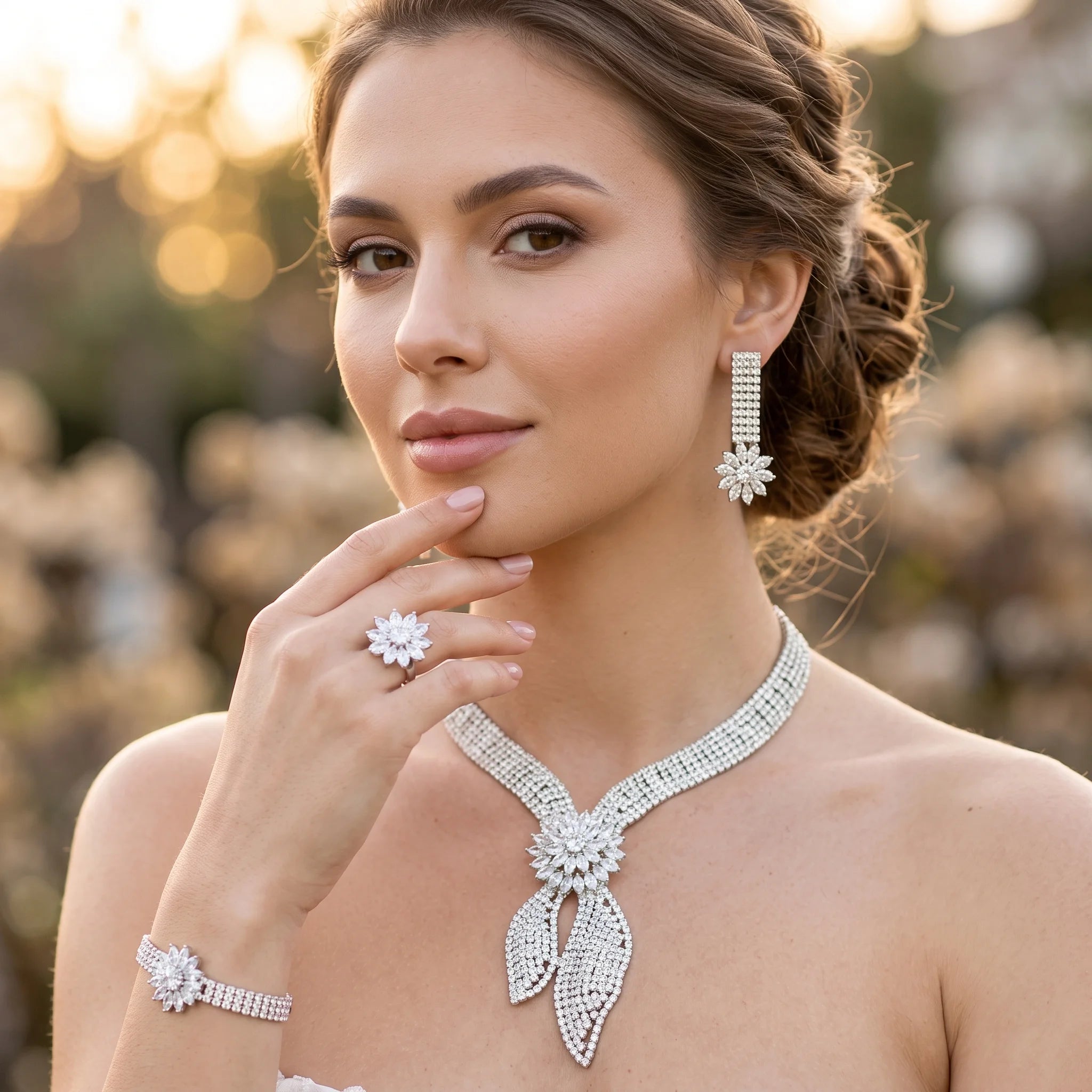 Smiling bride wearing a luxury bridal party wedding necklace set with a matching flower-shaped crystal ring and drop earrings.