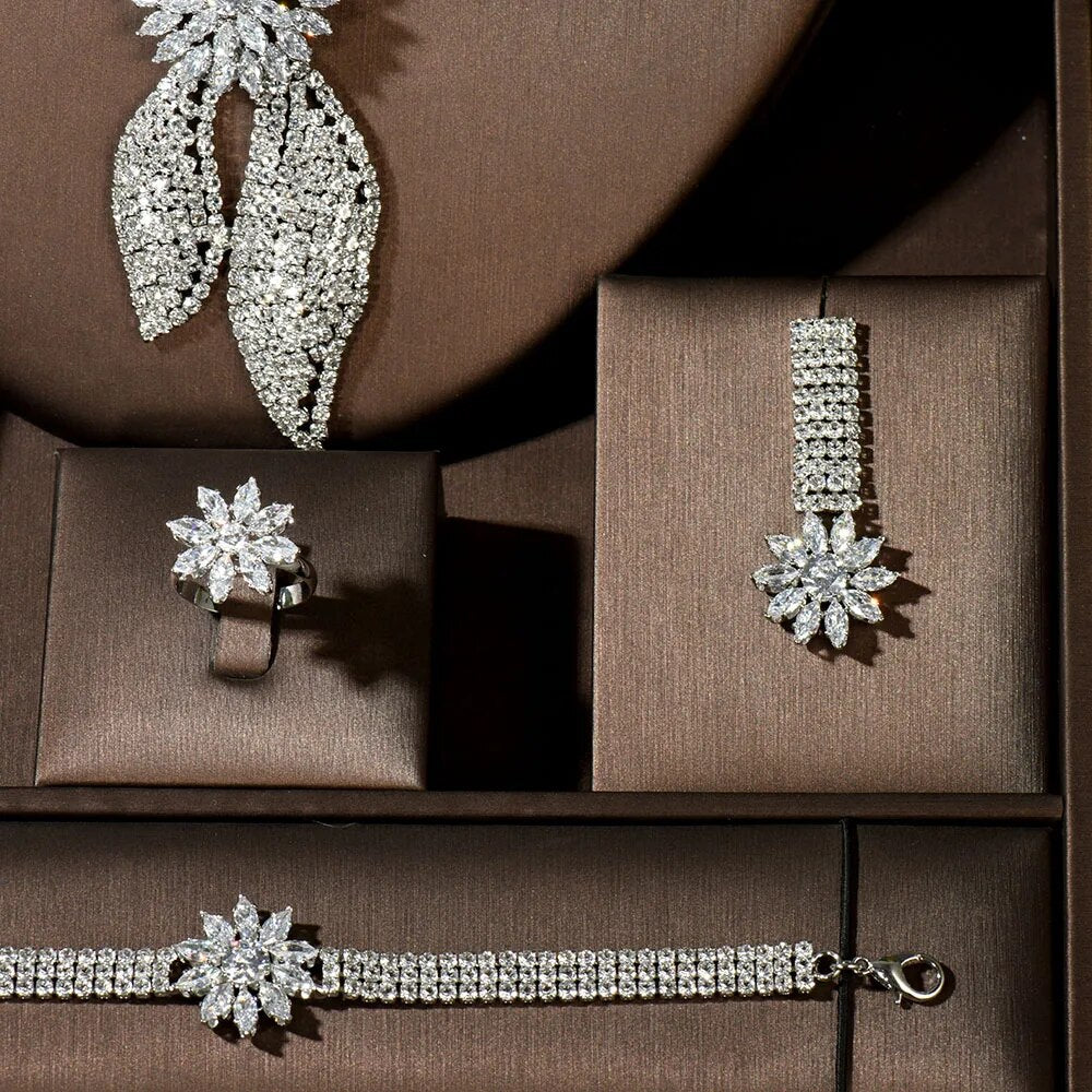 Close-up shot of the matching crystal flower ring, tiered rhinestone line earrings, and line bracelet from the bridal party jewelry collection.
