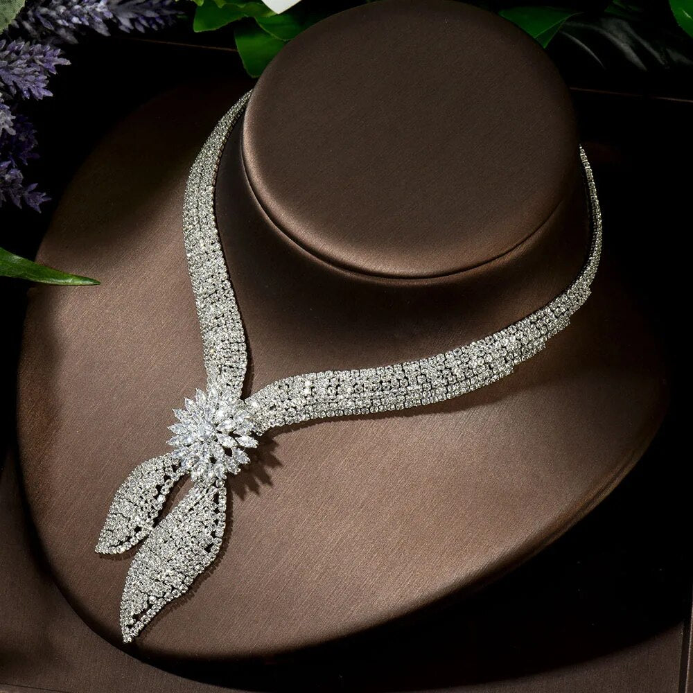 Close-up macro photograph highlighting the brilliant light-refracting marquise and round cut rhinestones on the central blossom pendant of the bridal necklace.