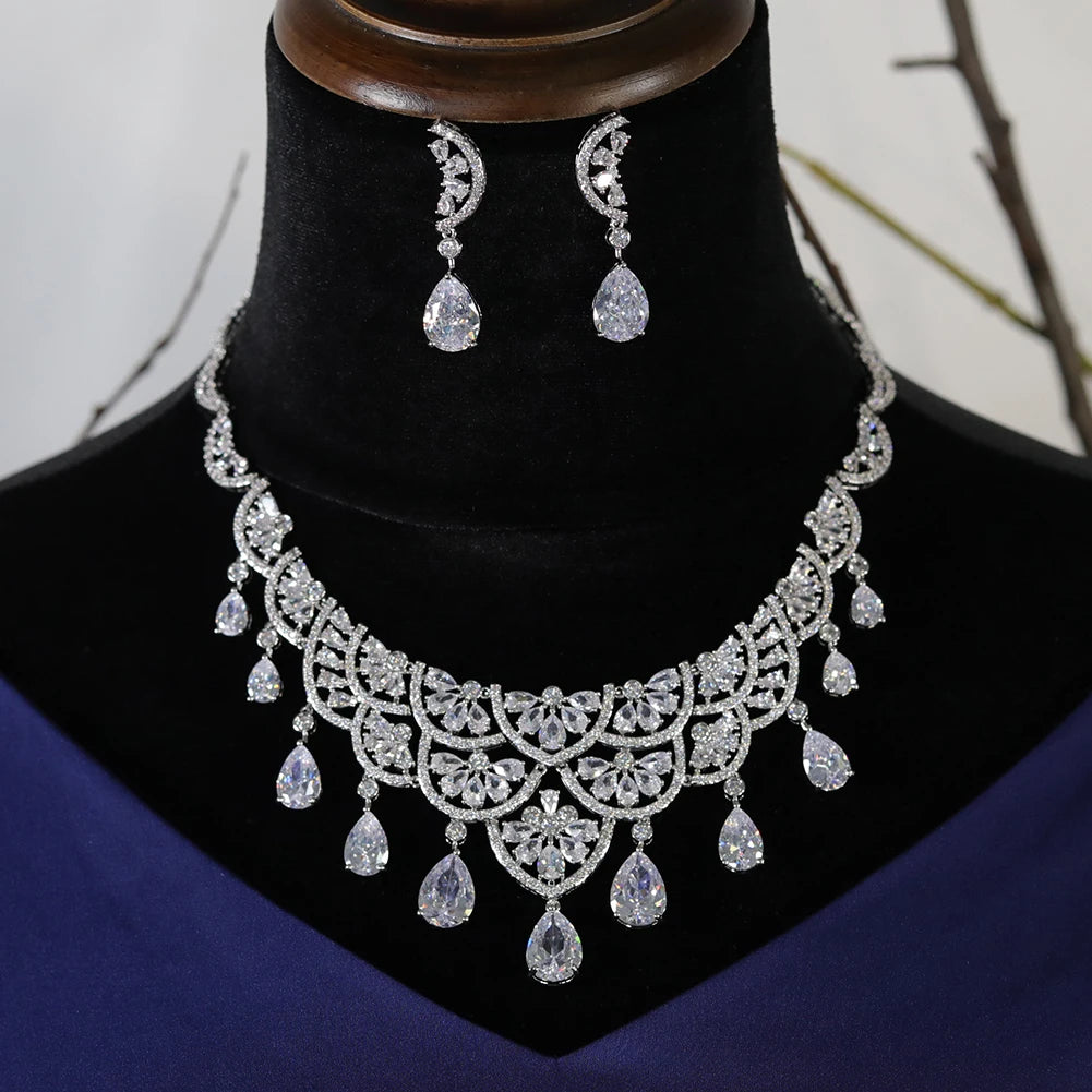 Front view of a luxury bridal water drop necklace and earring set displayed on a black velvet mannequin bust