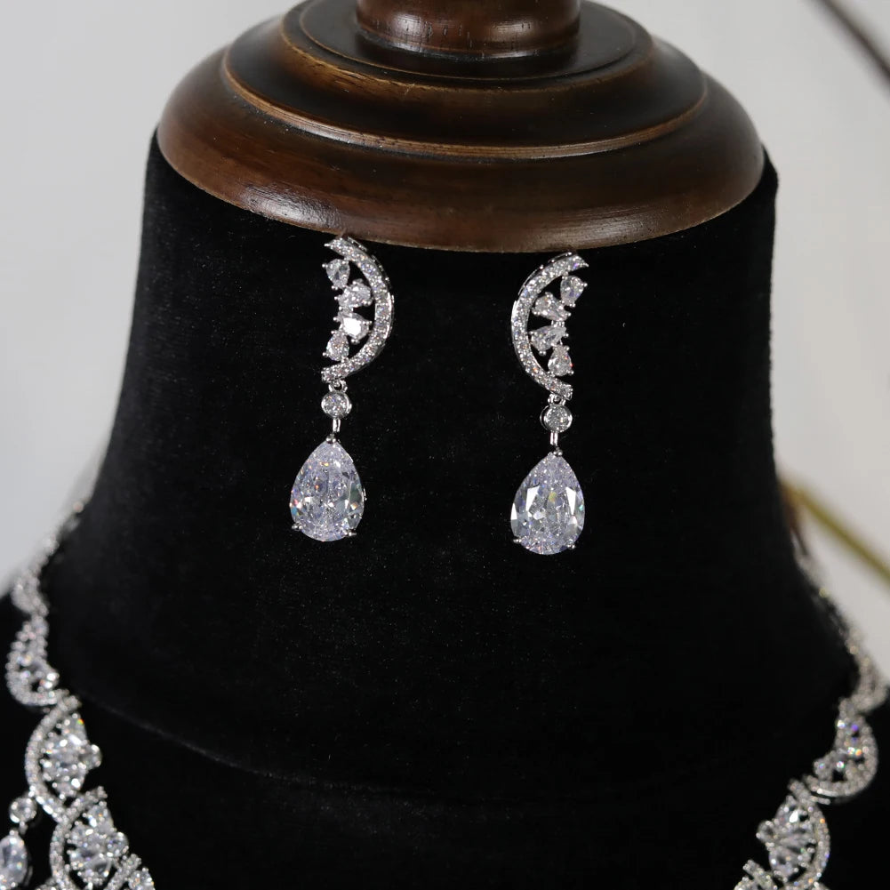 Close-up view of silver cubic zirconia water drop bridal earrings featuring intricate crescent details