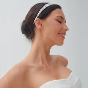 Side profile of a smiling model wearing a luxury CZ bridal headband with a clustered silver wedding hair design.