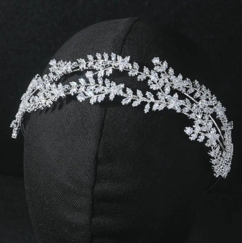 Close-up of a double-layered cubic zirconia leaf bridal headband on a mannequin display.