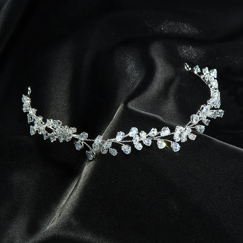 Luxury cubic zirconia bridal headpiece styled on a dark, textured fabric background.