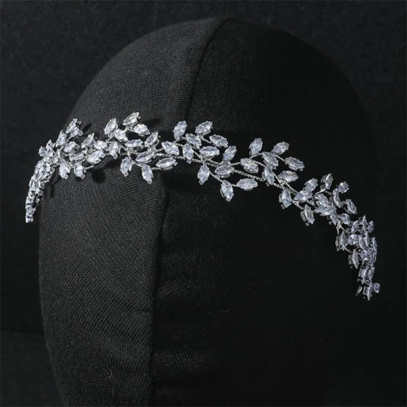 Close-up of a delicate leaf-design bridal headband worn on a mannequin.