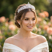 Close-up portrait of a smiling bride wearing a luxury CZ bridal tiara wedding headband with a high-pointed marquise crystal layout.