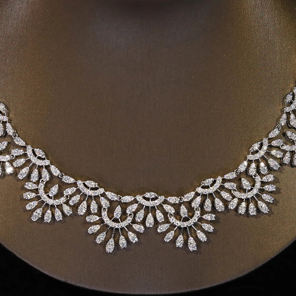 Close-up shot of the exquisite hollow lace craftsmanship on a silver zircon bridal necklace.