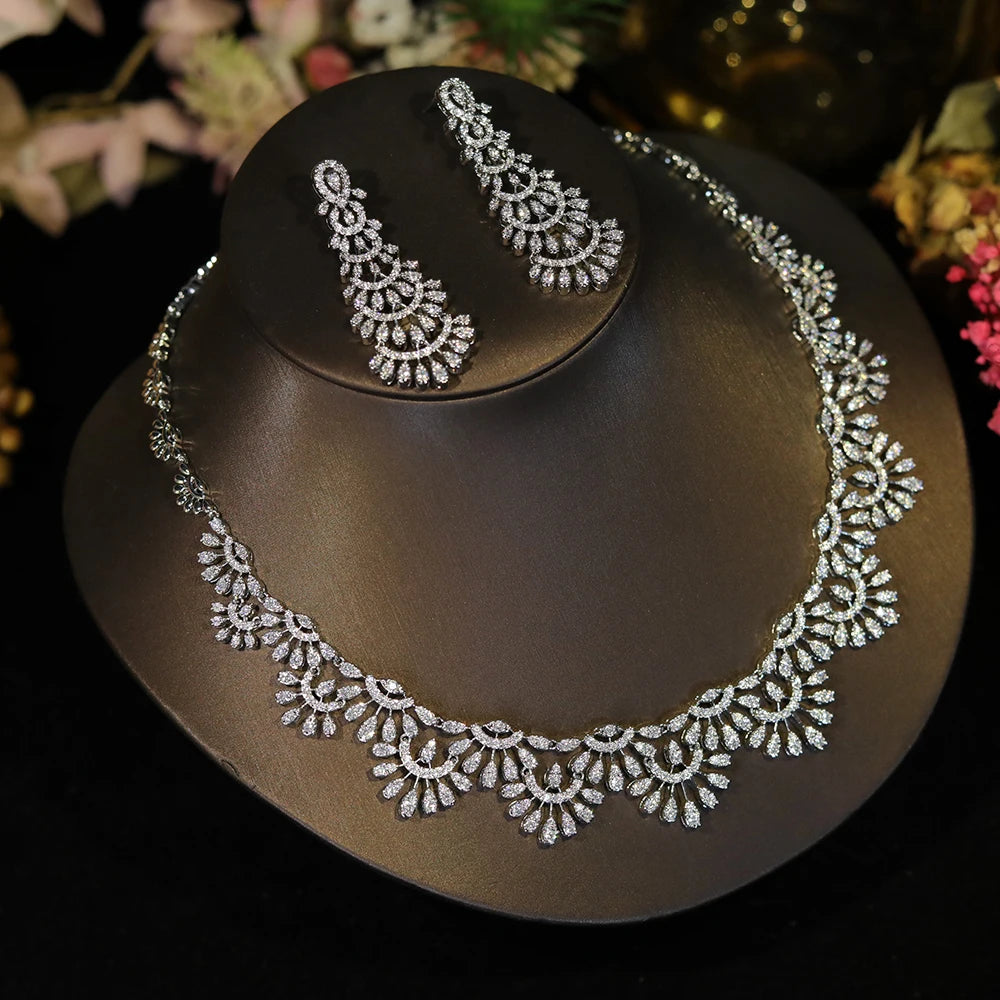 Overhead perspective of a silver cubic zirconia wedding necklace and matching statement dropdown earrings.
