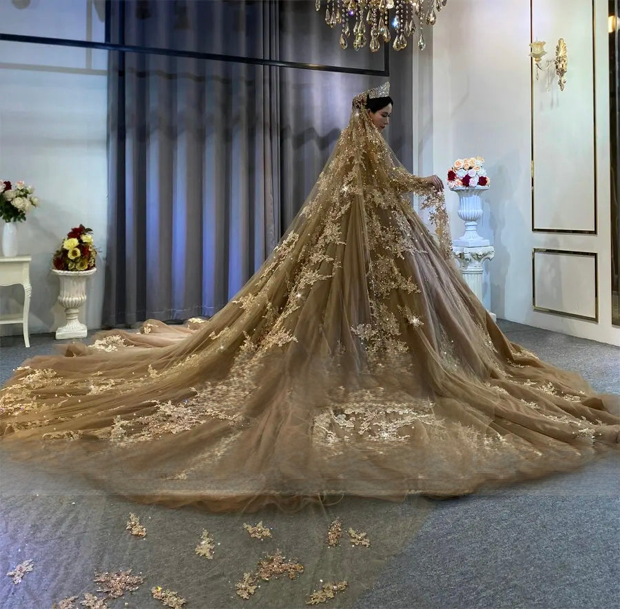 Side profile of a champagne beaded wedding dress highlighting the extraordinary length of the lace-bordered cathedral train and draped bridal veil.