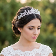 A bride wearing a luxury crystal bridal crown as a wedding hair accessory.