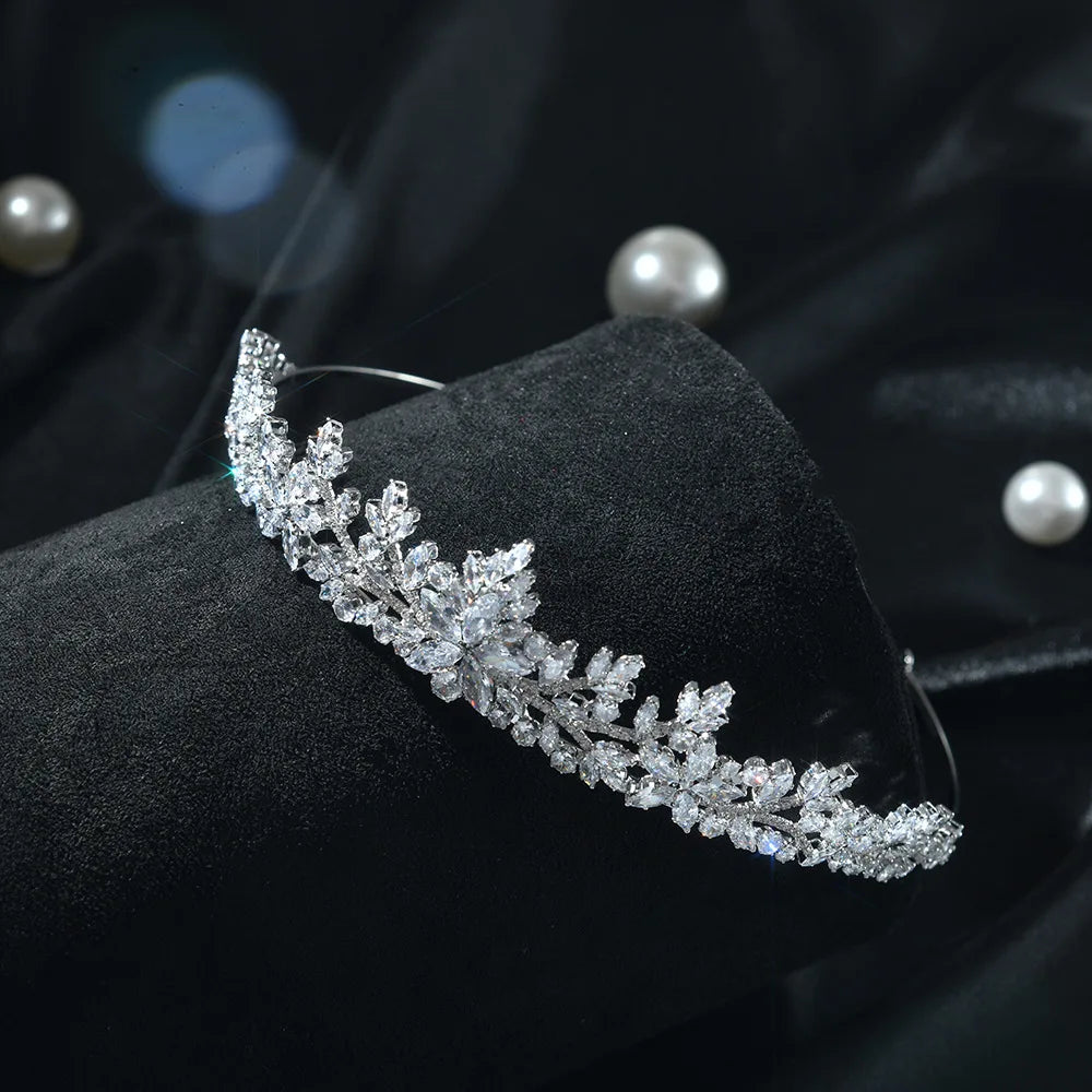 A detailed shot of a luxury crystal wedding tiara featuring intricate leaf-like designs.