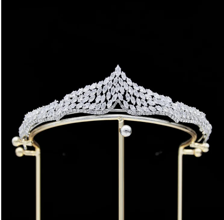 A close-up focus on the intricate crystal petal design of a silver wedding tiara.
