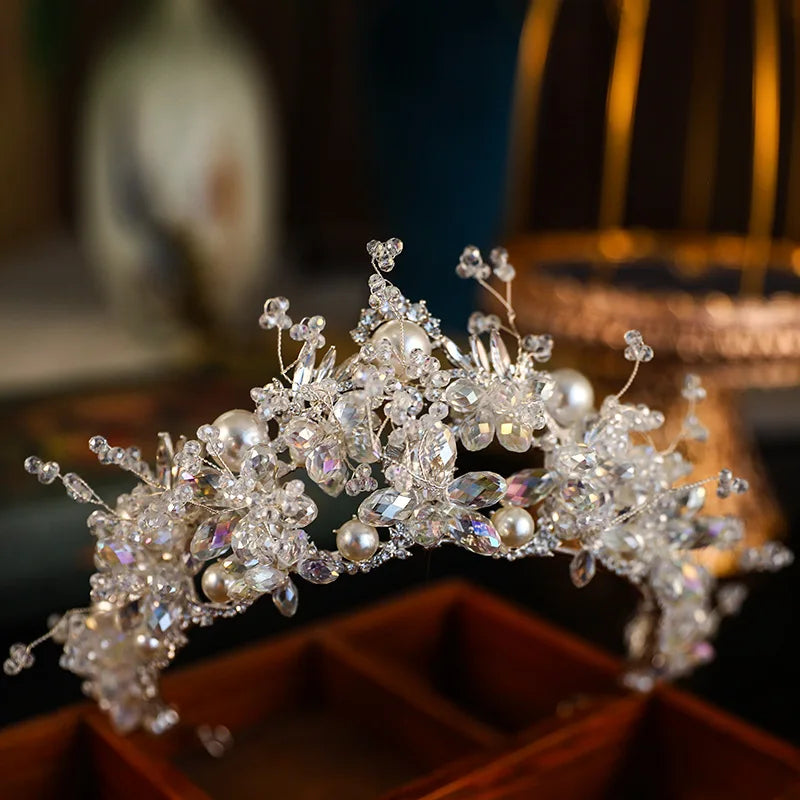Side angle view of a handmade wedding headband for brides, showcasing intricate crystal clusters and faux pearls.