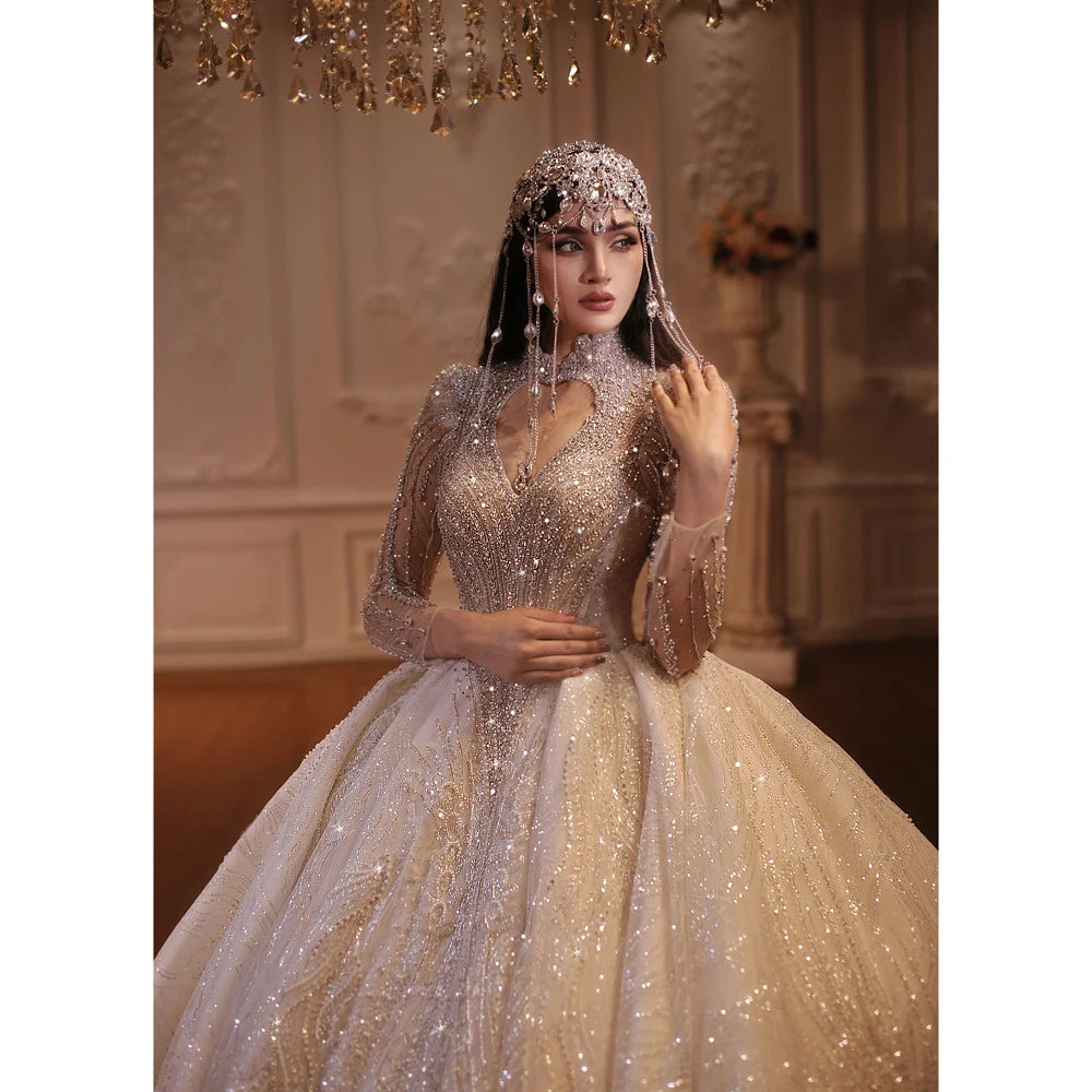 Elegant close-up of a bride in a luxury heavy-beaded wedding dress, highlighting the exquisite deep V-neckline with a high-neck illusion, sparkling silver embroidery, and an intricate crystal chain headpiece.