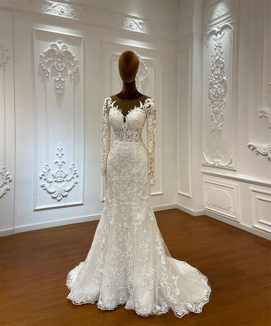 Rear view of a two-piece wedding dress highlighting the adjustable lace-up corset back and the massive, shimmering cathedral-length train of the detachable overskirt.