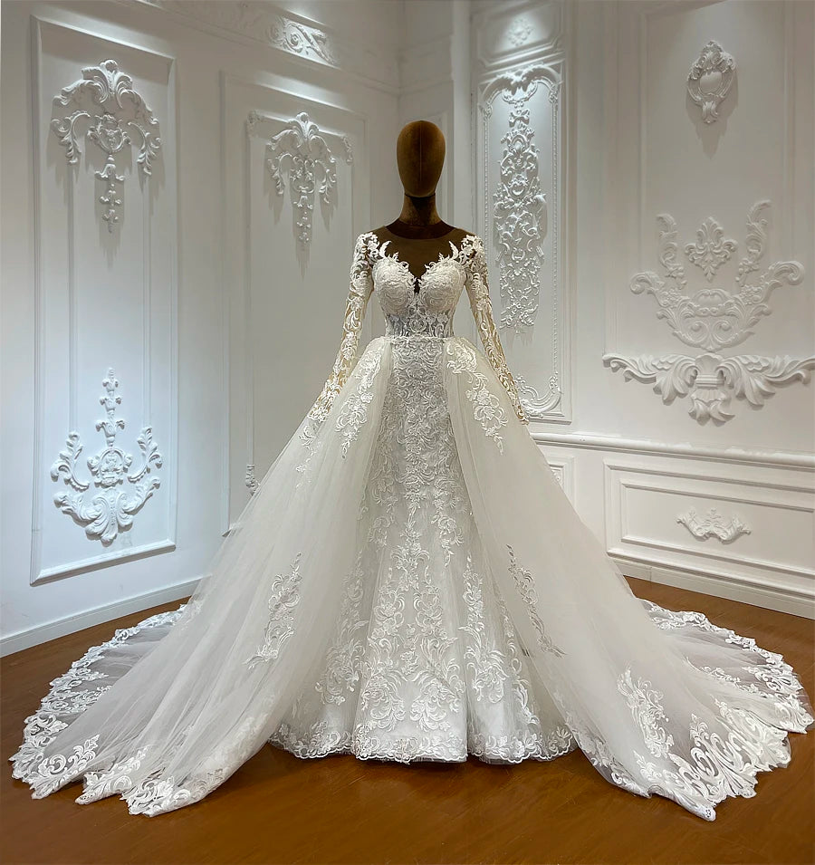 Full-length view of a shimmering 2-in-1 mermaid wedding dress, highlighting the majestic princess silhouette and the reflective silver crystal detailing.