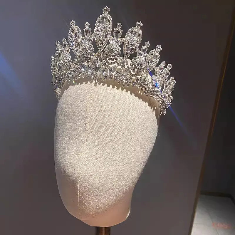 Elegant handmade bridal crystal crown displayed on a mannequin head for wedding jewelry inspiration.