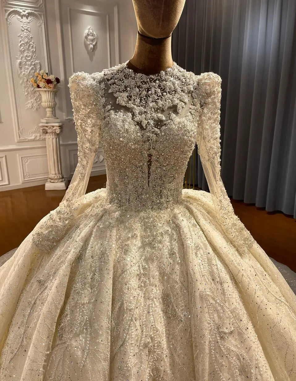 Front view of the luxury lace appliqued wedding dress on a mannequin, highlighting the exquisite heavy beading and sheer high-neck design.