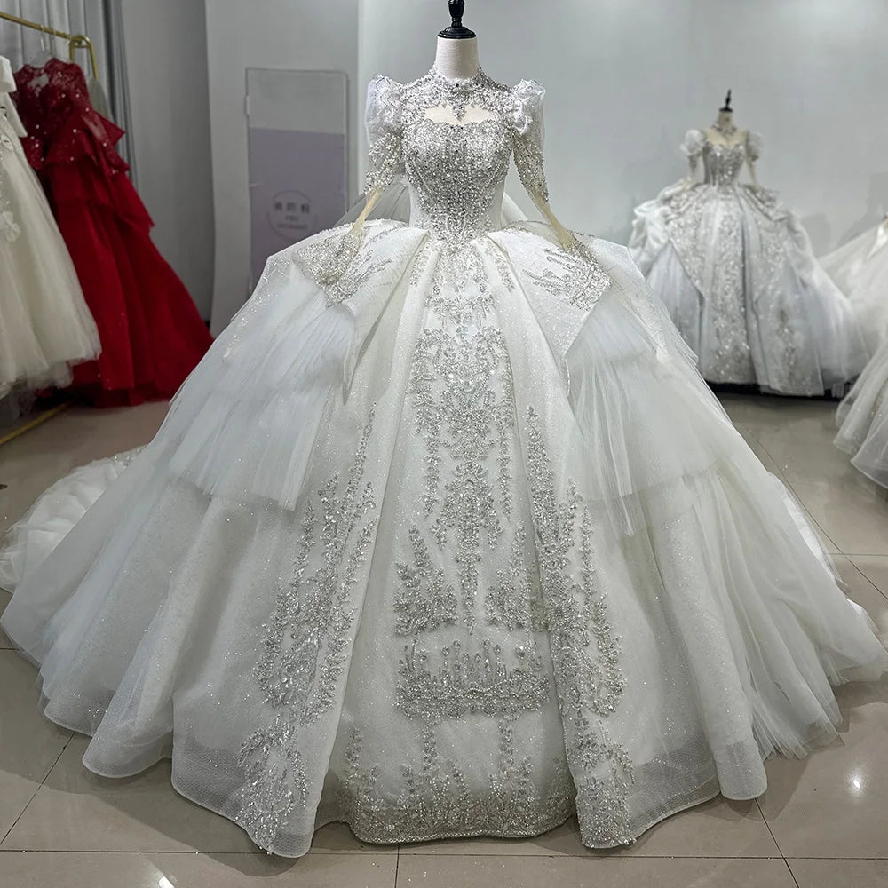Detailed shot of a luxury bridal gown's cathedral train spread across the floor, showcasing intricate scalloped lace edges and shimmering sequin detail.