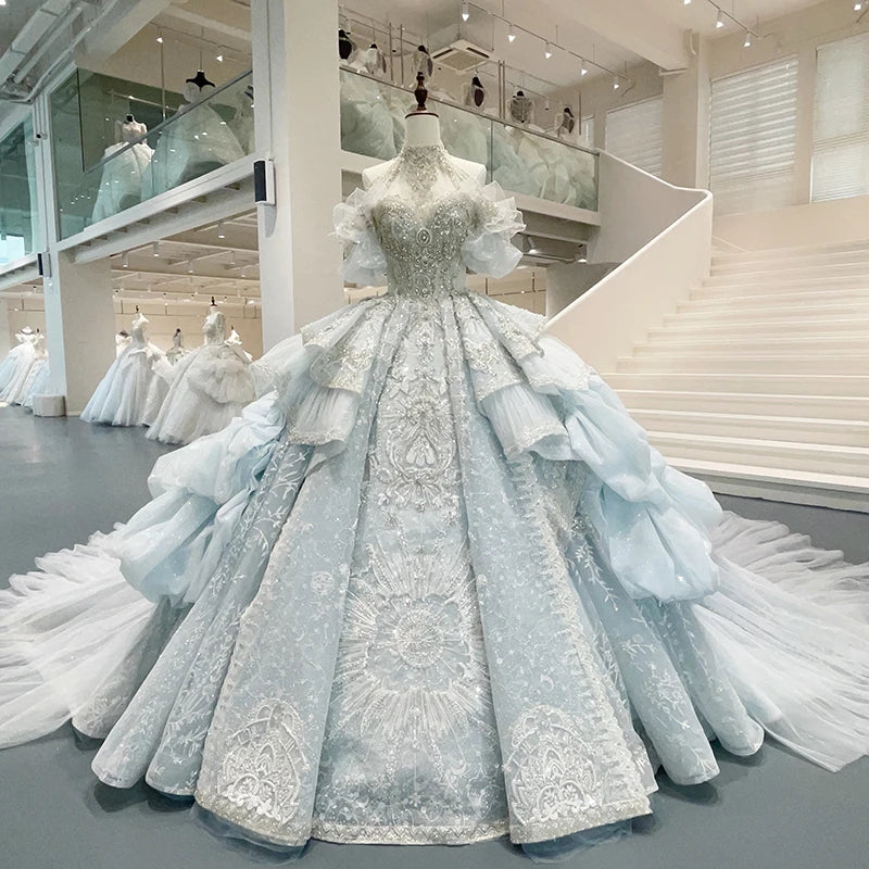 Front display of a luxury lace halter wedding dress on a mannequin, highlighting the crystal-beaded keyhole neckline and voluminous organza ball gown skirt.