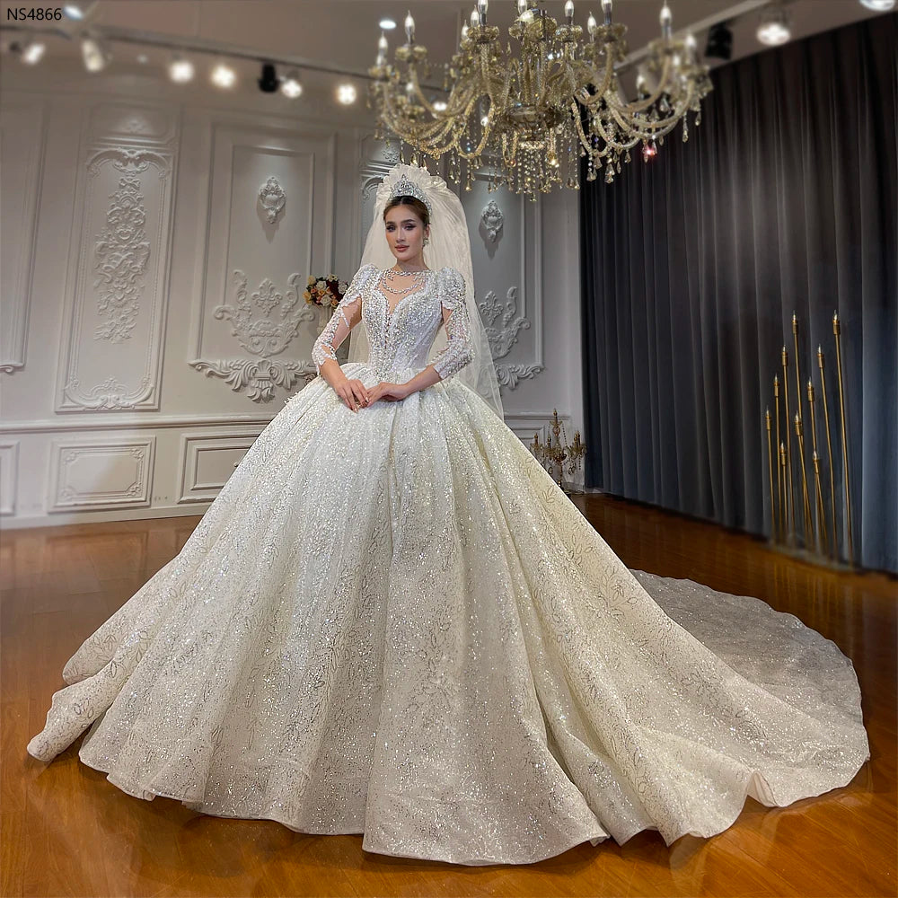 Full front view of a luxury lace ball gown wedding dress featuring a high mandarin collar, long sleeves, and a majestic floor-length matching lace cape.