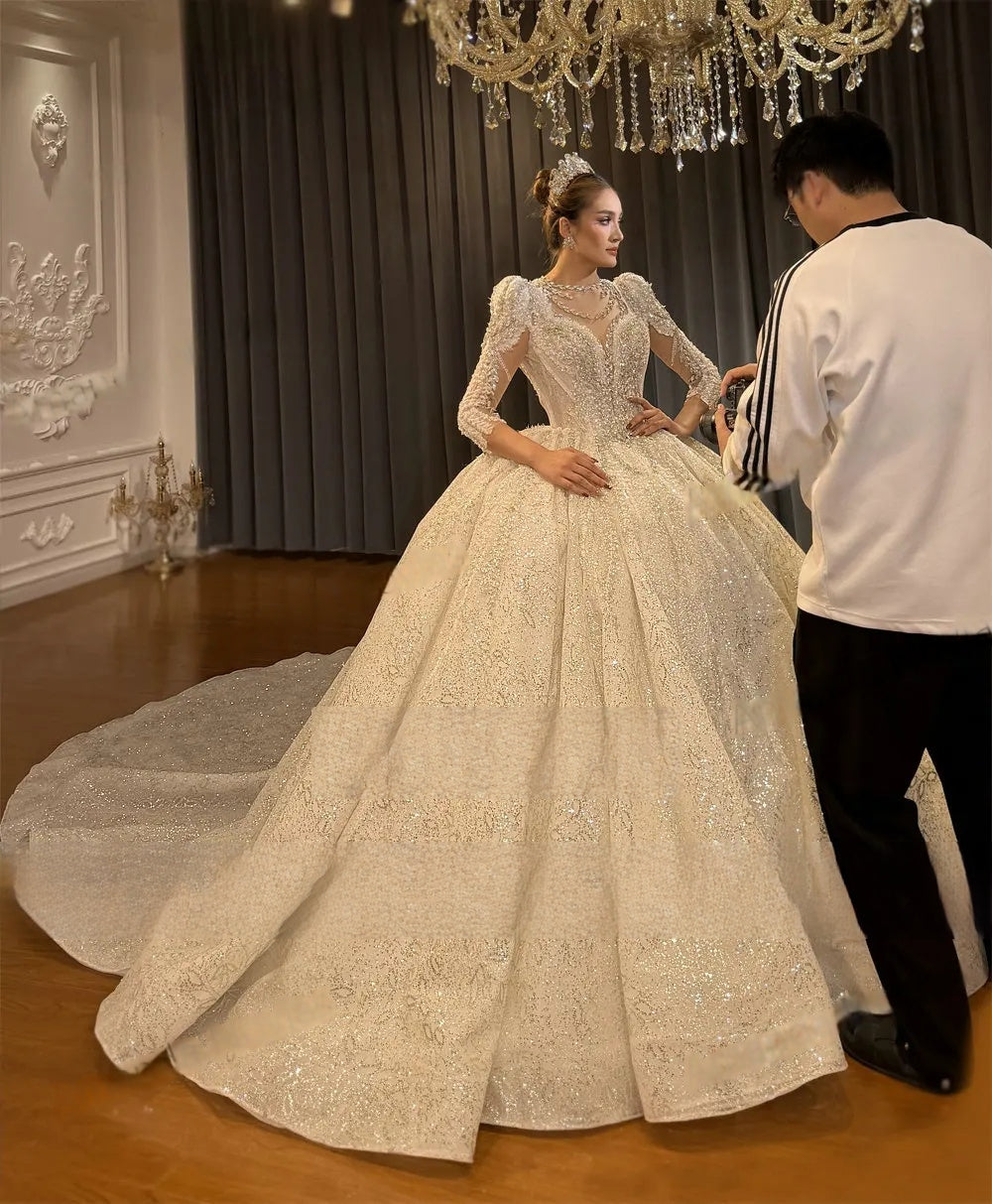 Back view of a luxury lace wedding dress with an expansive cathedral train and a dramatic sheer lace cape, highlighting the royal princess silhouette.