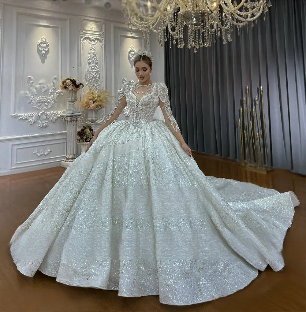 Close-up of the bodice and mandarin collar of a luxury lace wedding dress, showcasing dense pearl beading and the elegant drape of the matching long lace cape.
