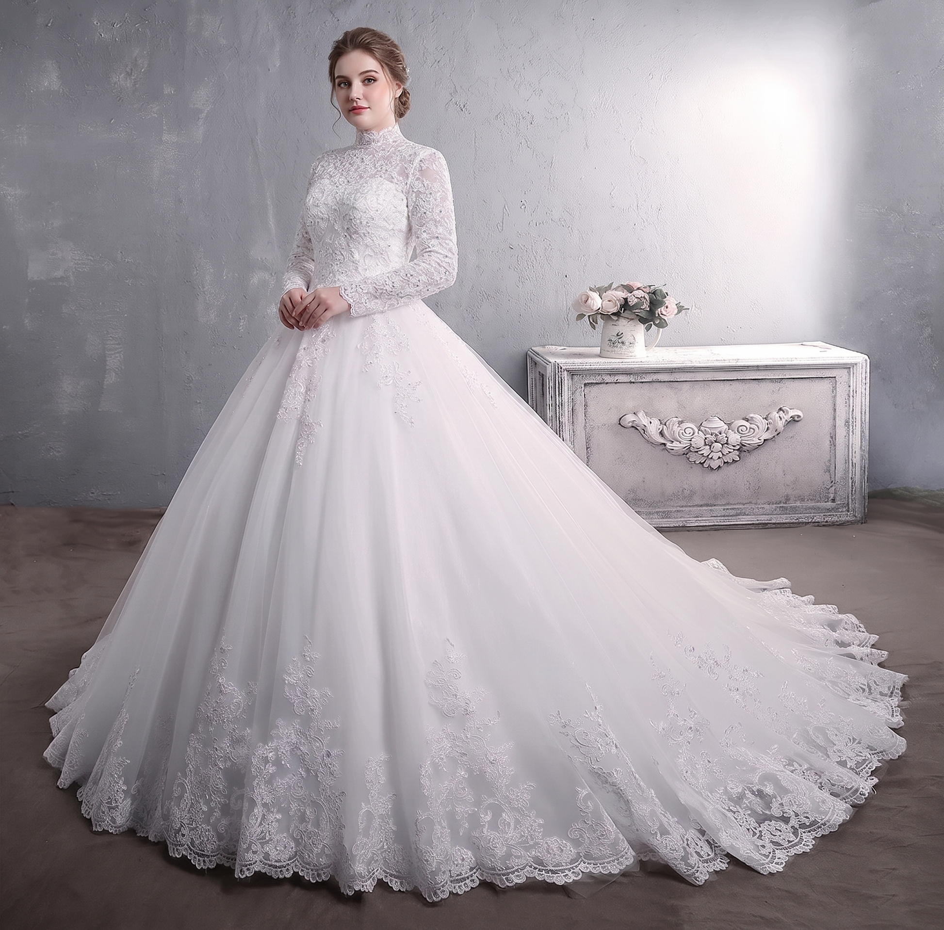 Detailed back view of the luxury high-neck bridal gown, showcasing a sheer illusion lace back with a secure zipper closure hidden under elegant faux buttons and an expansive cathedral train.