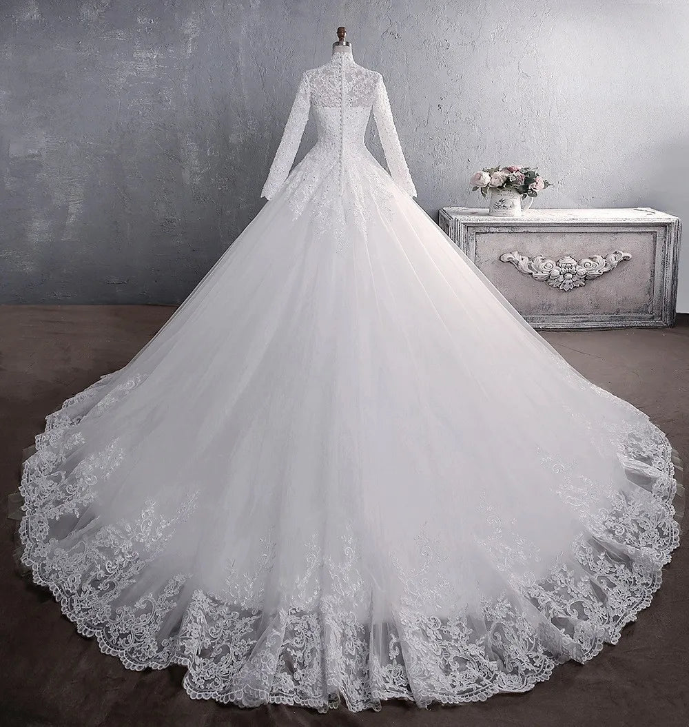 Exquisite close-up detail of the scalloped floral lace trim, sequin accents, and embroidery running along the bottom hemline of the expansive ball gown skirt.