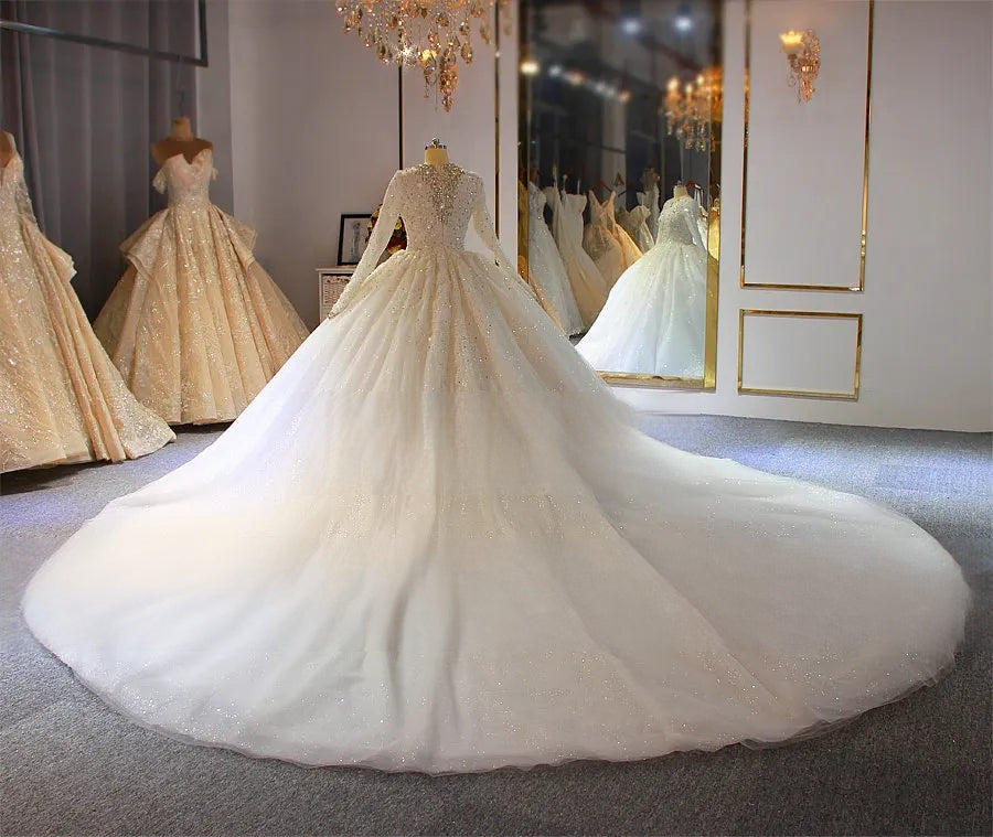Elegant rear view of a luxury Muslim wedding dress highlighting a dramatic cathedral-length train and a modest full-cover bridal silhouette.
