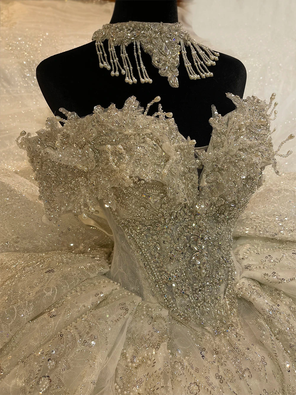 Back view of an elegant lace wedding dress highlighting a dramatic cathedral train and a structured lace-up back.