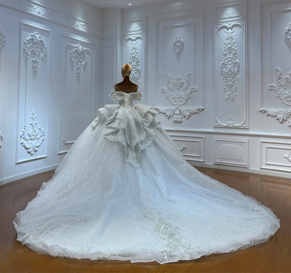Sophisticated A-line luxury French lace wedding gown with a shimmering skirt and detailed high-quality embroidery.