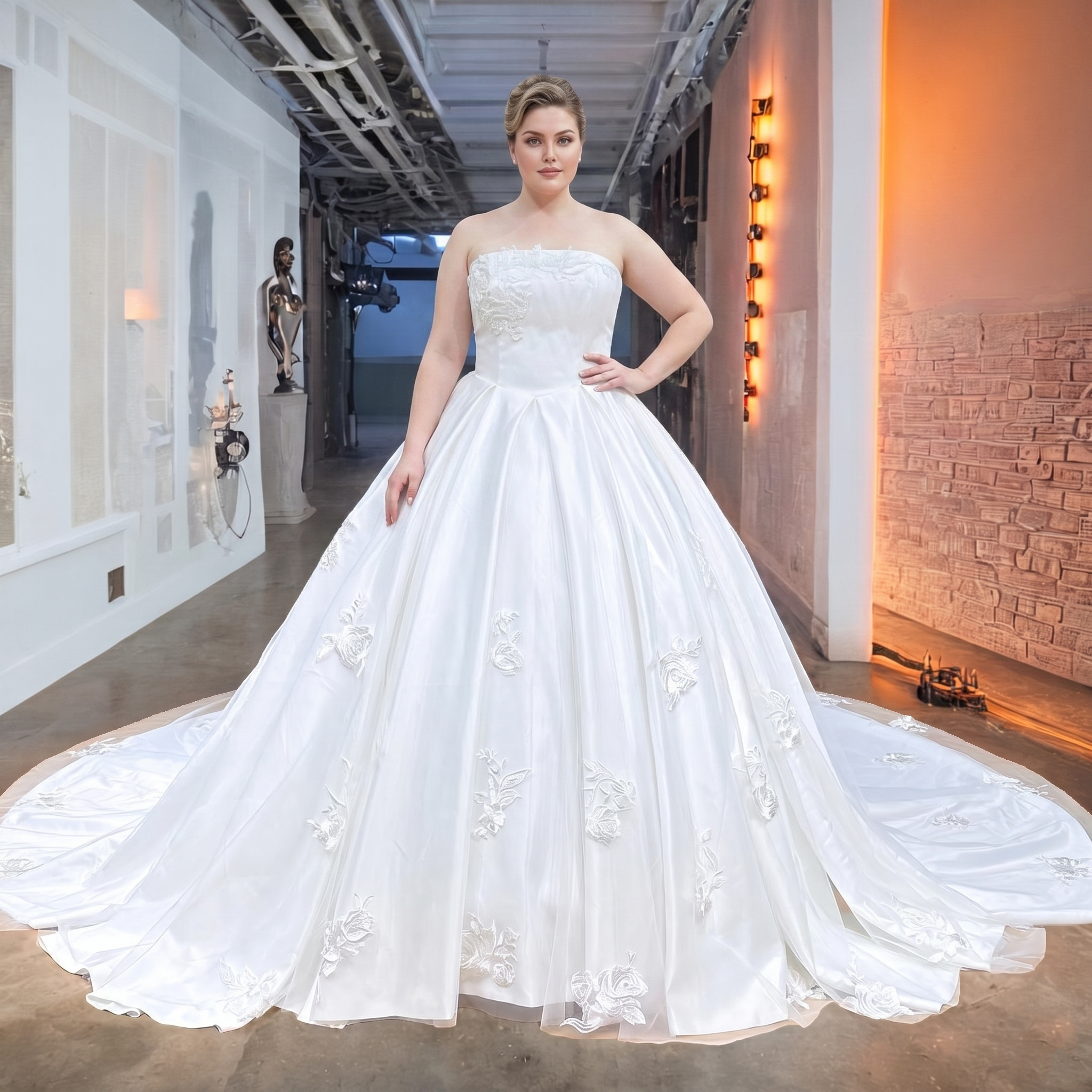 Plus-size bridal model in a modern indoor gallery setting showcasing a luxury ball gown wedding dress, featuring an elegant off-shoulder boat neck, pleated satin skirt, and scattered floral embroidery.