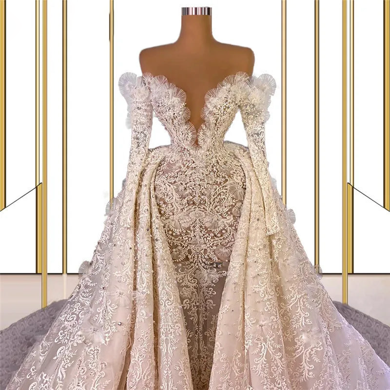 Luxury Muslim mermaid wedding dress with an open-front detachable train overlay on a dress form, emphasizing the dense baroque lace appliques and plunging sweetheart neck.