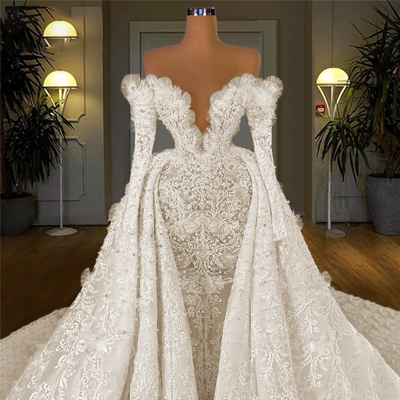 Opulent ice white long sleeve Arabic bridal gown torso on a mannequin, capturing the crisp contrast between the intricately embroidered sheer lace base and the rows of heavy premium beadwork.