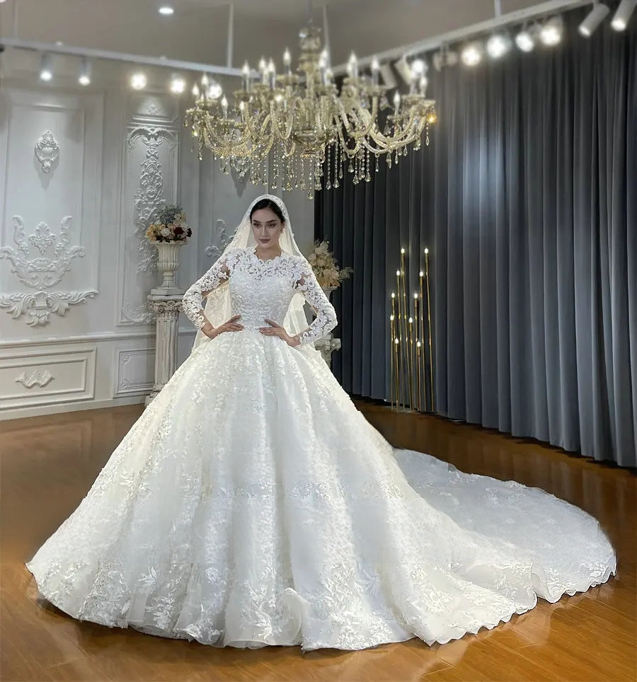A regal side-view of a modest Muslim wedding dress with a voluminous ball gown silhouette, showcasing the delicate pearl and sequin embellishments throughout the off-white lace.