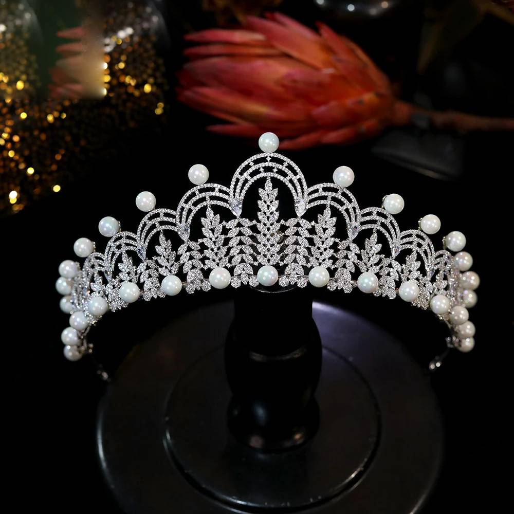Symmetrical front profile of the luxury queen-style CZ tiara bridal crown balanced elegantly on a black display mount.