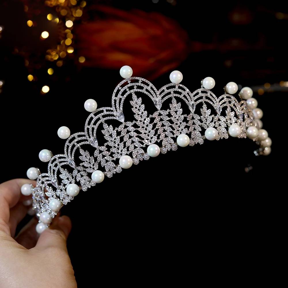 Side-profile perspective of the elegant rhinestone bridal crown tiara, demonstrating its arched framework and glistening properties.